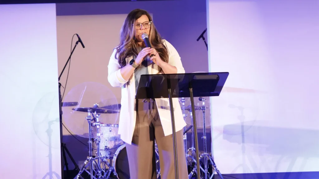 A woman sitting quietly with grocery bags slipping from her arms symbolizing exhaustion, pressure, and God’s grace meeting us in weakness during the Grace Over Guilt message.