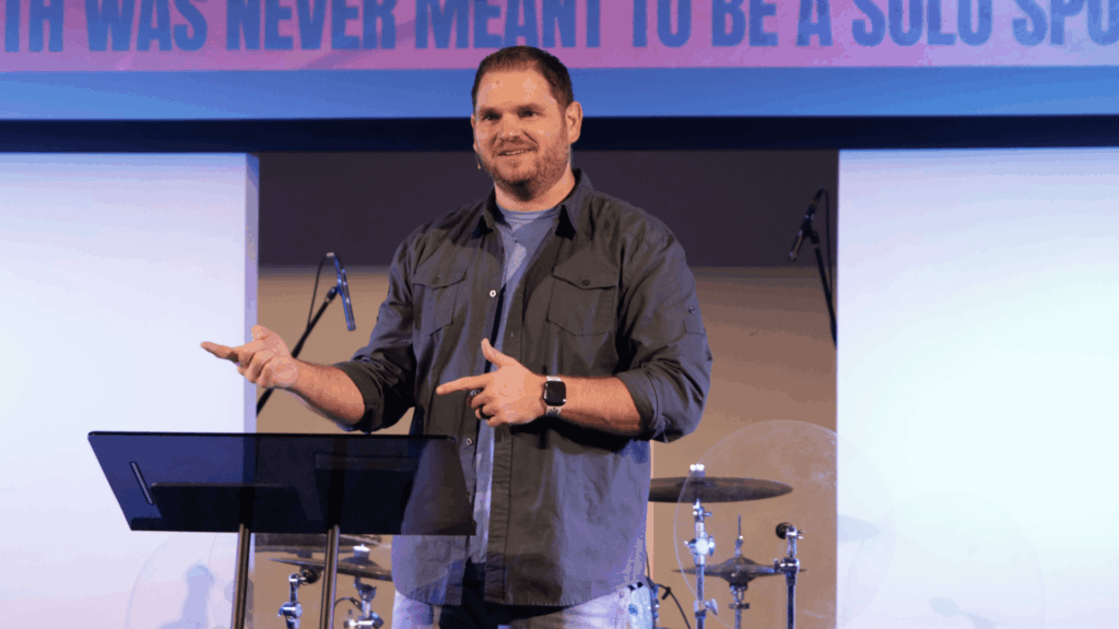 Pastor Alex Graves preaching at Anchor Church during the "We>Me" sermon series, teaching how the voices we allow to influence us shape our faith and future.